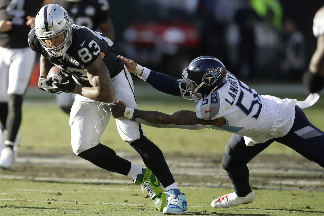 Oakland Raiders tight end Darren Waller (83) runs past Tennessee Titans linebacker Harold Landr ...