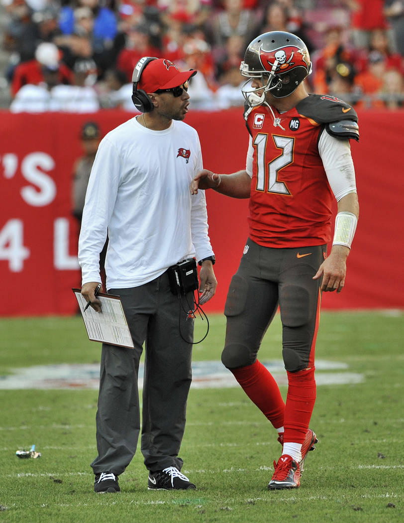 Tampa Bay Buccaneers quarterback Josh McCown (12) talks with coach Marcus Arroyo, left, during ...