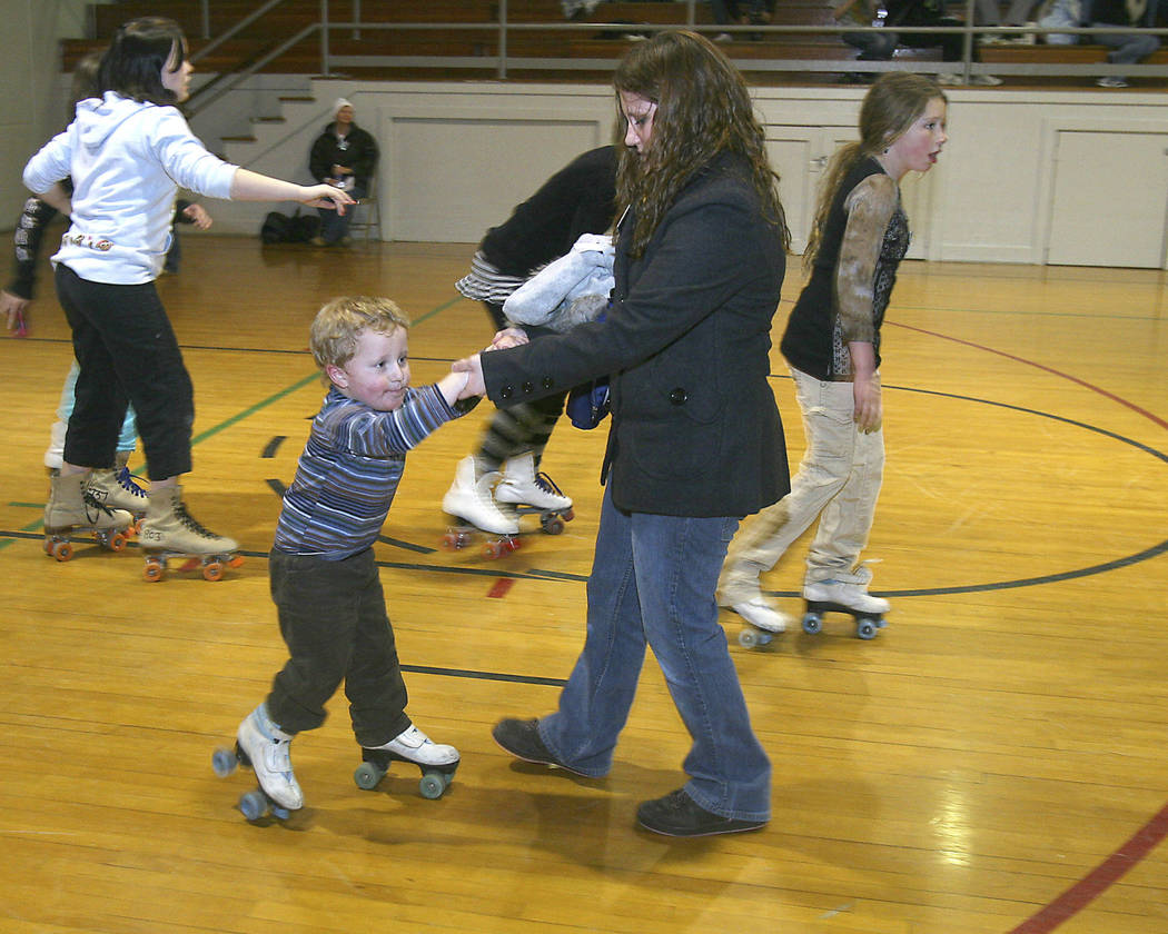 Mary Girard helps Joseph Mellow, 2, learn to skate during the Boulder City's First Night Festiv ...