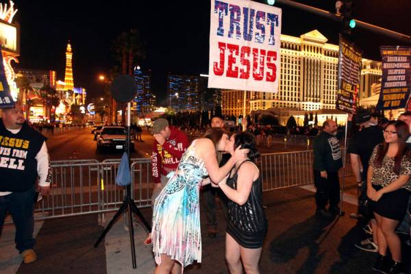 Revelers taunt street preachers with a kiss on the Las Vegas Strip near Flamingo Road on New Ye ...