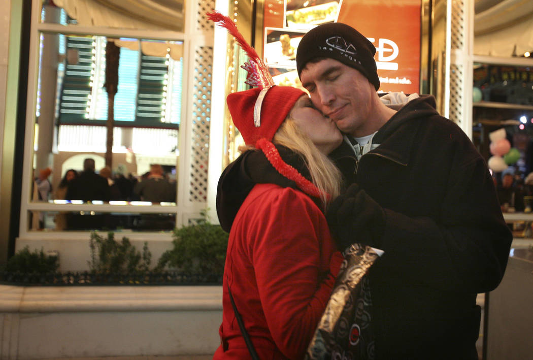 A couple embraces moments before 2011 arrives at the Fremont Street Experience in Las Vegas. (J ...