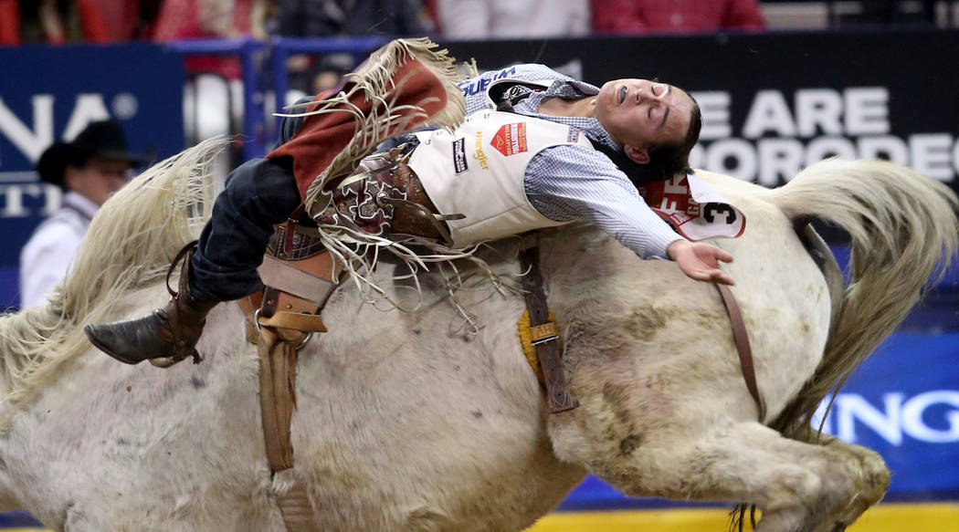 Clayton Biglow of Cleements, Calif. rides Mucho Dinero during the ninth go-around of the Wrangl ...