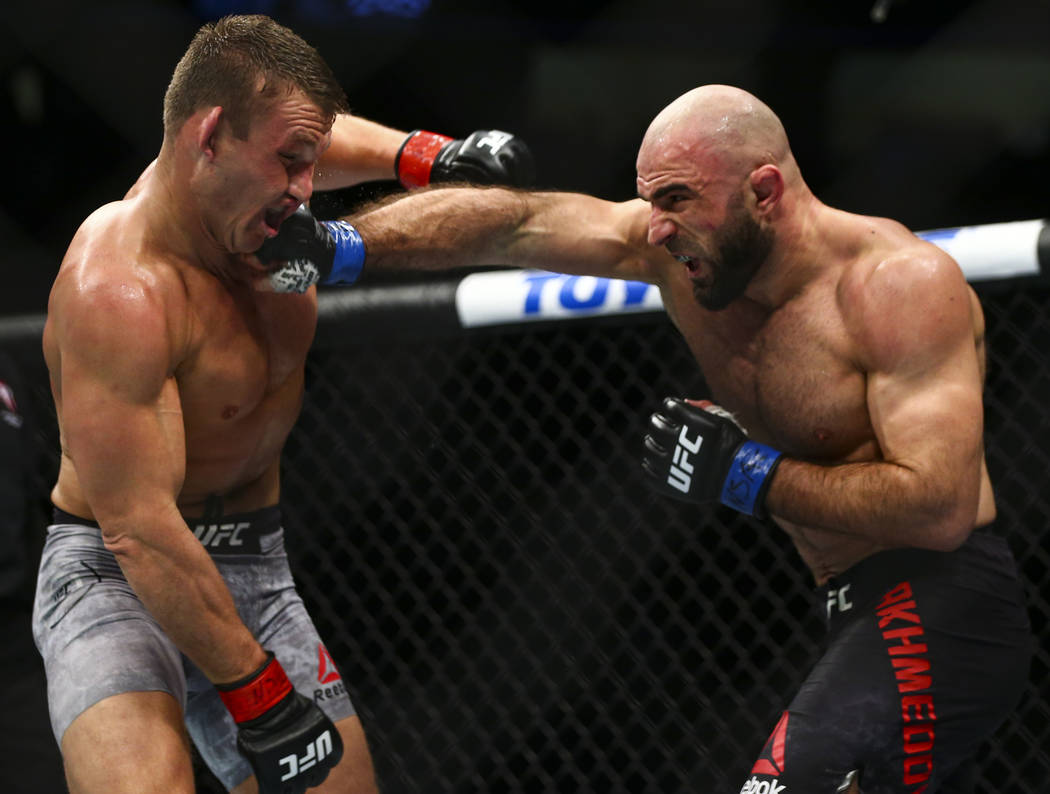 Omari Akhmedov, right, delivers a jab to Ian Heinisch during their middleweight bout in UFC 245 ...