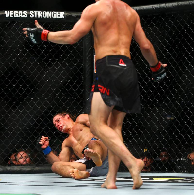 Petr Yan, right, knocks out Urijah Faber to win their bantamweight bout in UFC 245 at T-Mobile ...