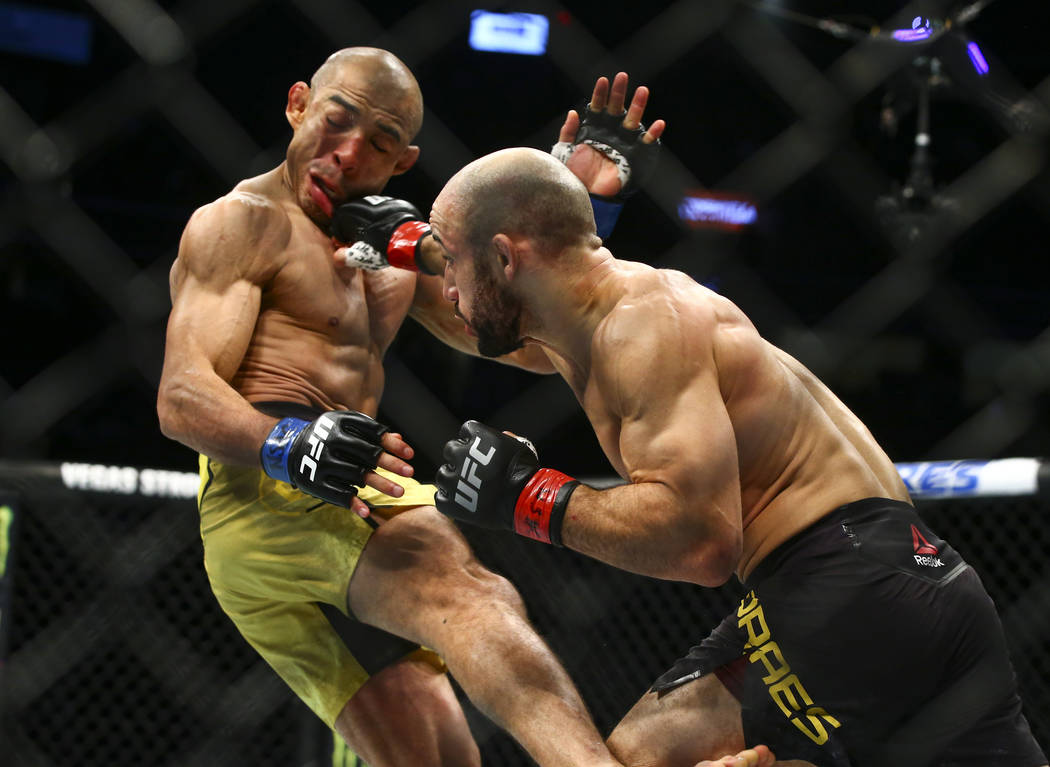 Jose Aldo takes a hit from Marlon Moraes during their bantamweight bout in UFC 245 at T-Mobile ...