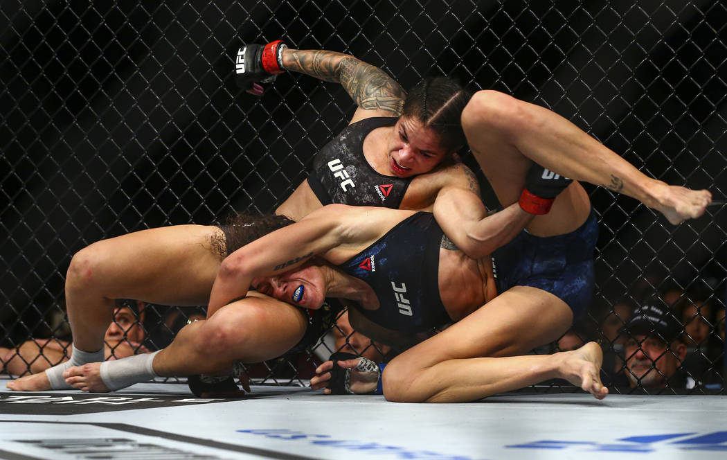 Amanda Nunes, left, fights Germaine de Randamie during their bantamweight title bout in UFC 245 ...