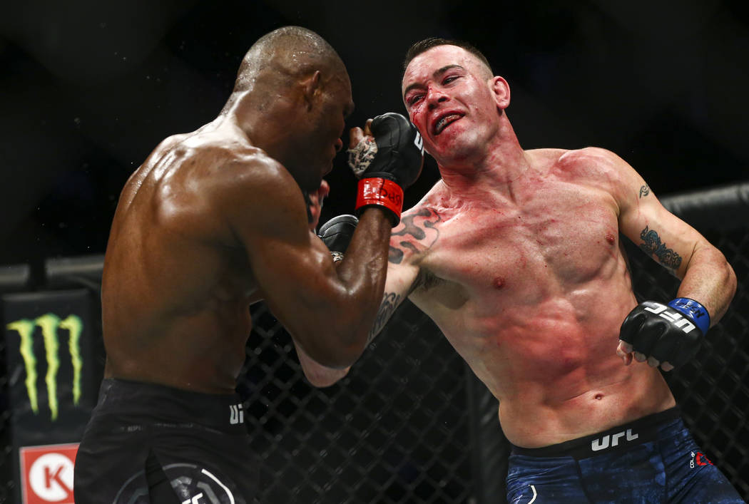 Kamaru Usman, left, fights Colby Covington during their welterweight title bout UFC 245 at T-Mo ...