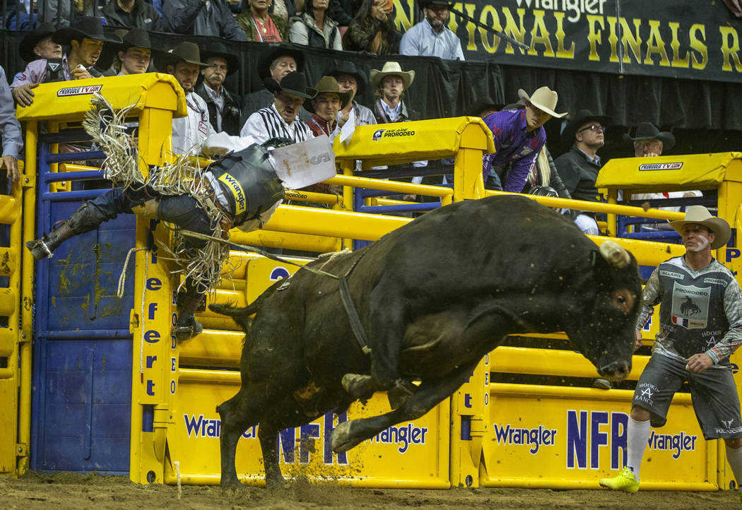 Stetson Wright of Milford, Utah, clings to the gate after being thrown from Pickup Man in Bull ...