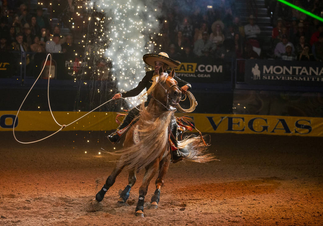 A trick roper performs as part of the opening act during the tenth go round of the Wrangler Nat ...
