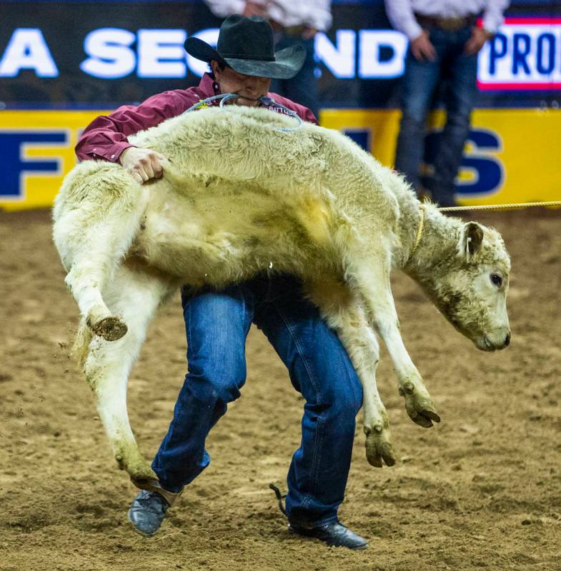 Haven Meged of Miles City, Mont., lifts a steer in Tie-Down Roping at the tenth go round of the ...