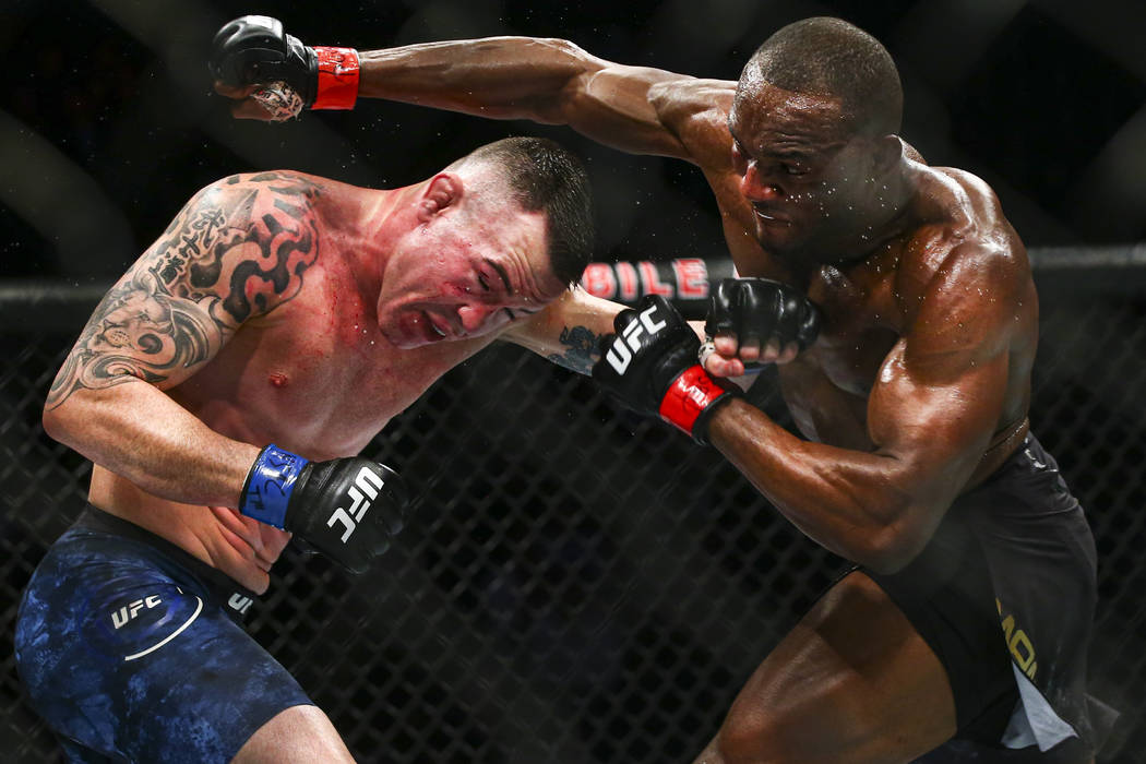 Kamaru Usman, right, fights Colby Covington during their welterweight title boutÊin UFC 24 ...