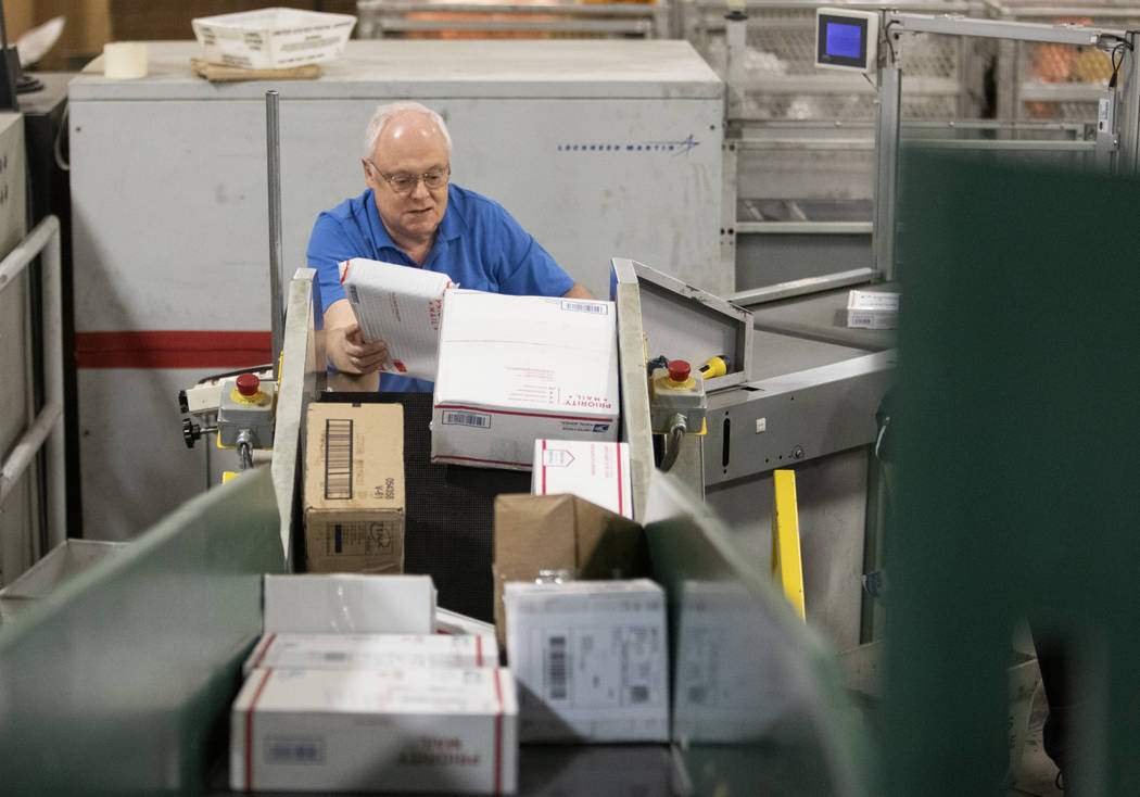 Chuck Thieman, who has worked at the USPS Mail Processing Annex for more than 30 years, sorts p ...