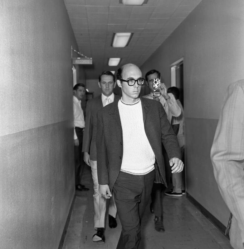 Russell Payne, 25, is taken through a corridor at Clark County Courthouse after surrendering in ...