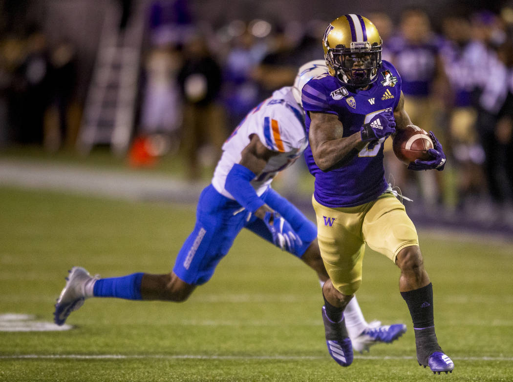 Washington Huskies wide receiver Chico McClatcher (6, right) eyes the end zone as Boise State B ...