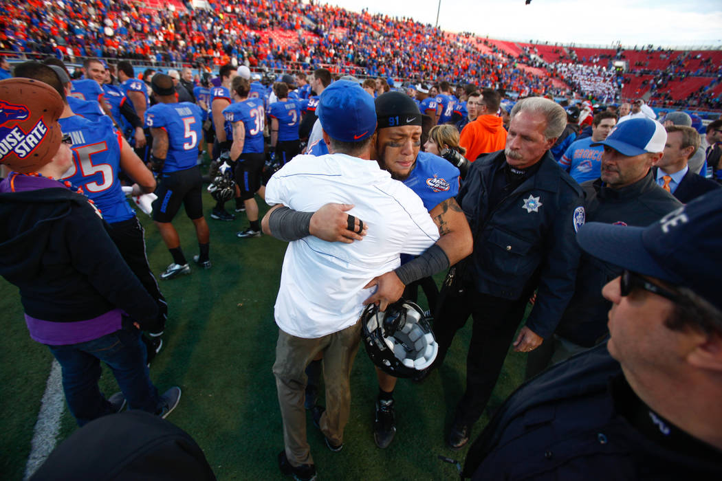 Boise State head coach Chris Petersen hugs player Greg Grimes after defeating Washington 28-26 ...