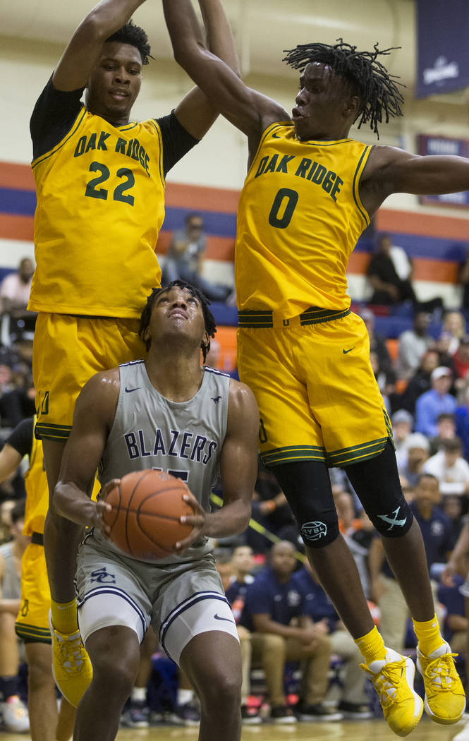 Sierra Canyon senior forward Terren Frank (15) pump fakes Oak Ridge defenders Michael James (0 ...