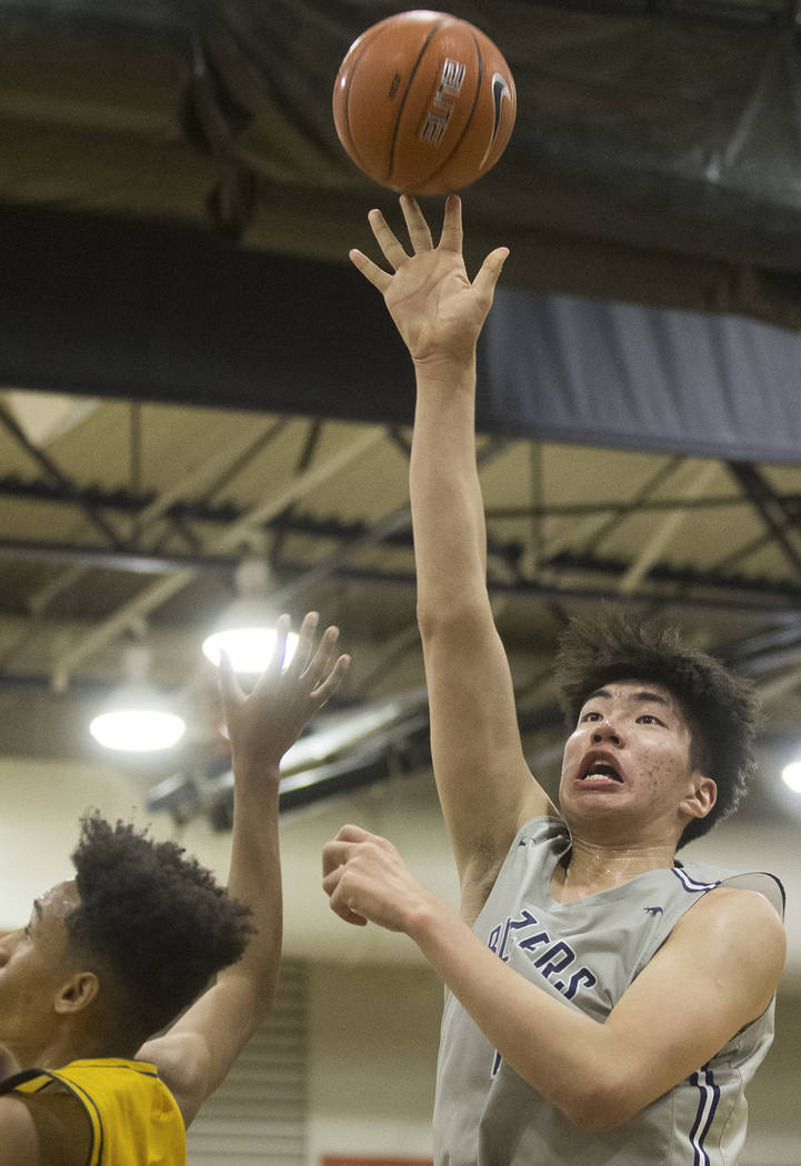 Sierra Canyon junior center Harold Yu (11) shoots over Oak Ridge sophomore guard Fabio Basili ( ...