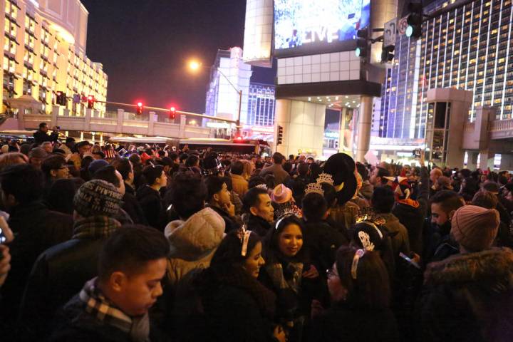 Thousands gather on Las Vegas Boulevard at Flamingo Road awaiting the New Year’s Eve fi ...