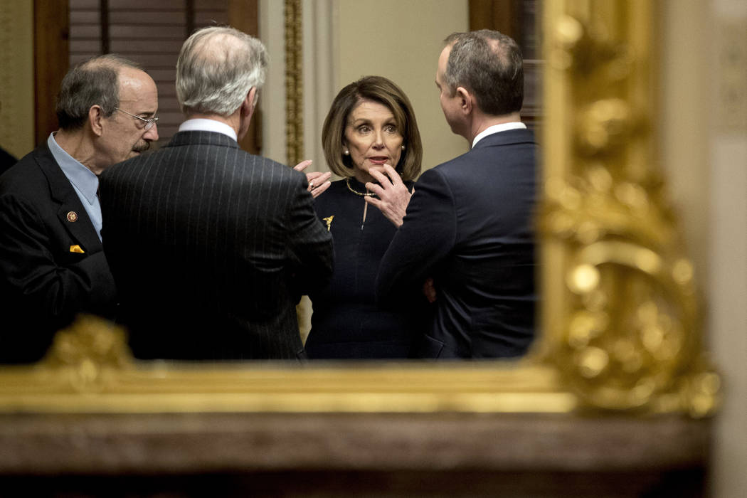 House Speaker Nancy Pelosi of Calif., center, speaks with House Intelligence Committee Chairman ...