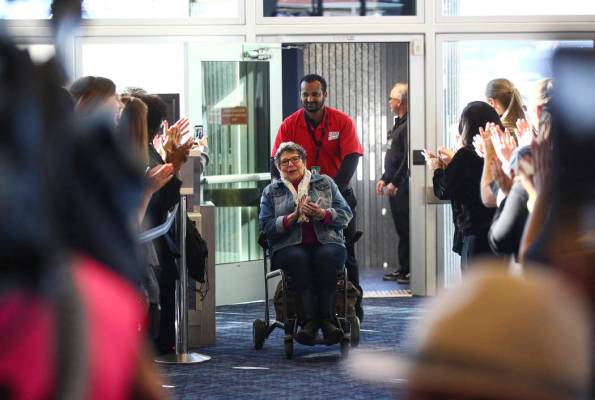 Passengers deplaning from an Allegiant flight from San Antonio are welcomed with cheers during ...
