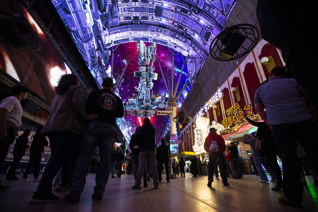 People watch the recently-upgraded Viva Vision screen during a preview of the new light show, & ...