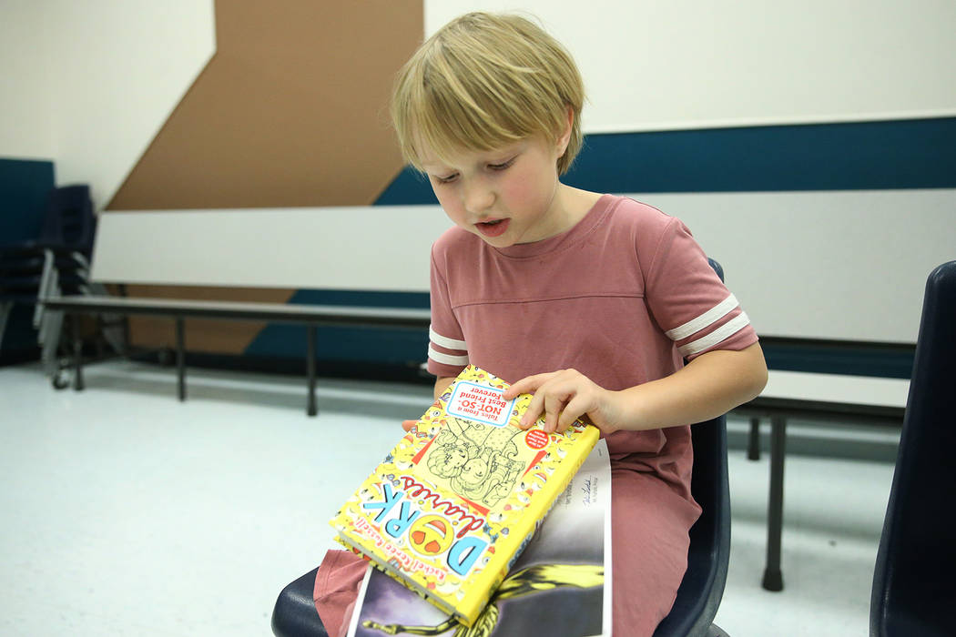 Second-grade-student Emily Krupka, 7, shows a book she got from a book vending machine at Frank ...