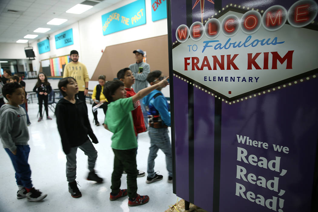 Students look at a book vending machine at Frank Kim Elementary School in Las Vegas, Thursday, ...