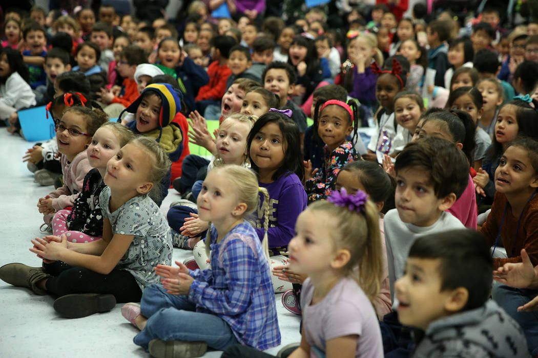 Students react as a book bending machine is unveiled during a ceremony at Frank Kim Elementary ...