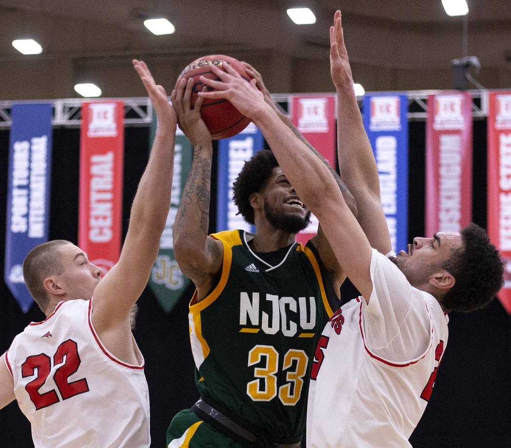 New Jersey City University's center Quadri Moore (33) shoots a point as University of Wisconsin ...