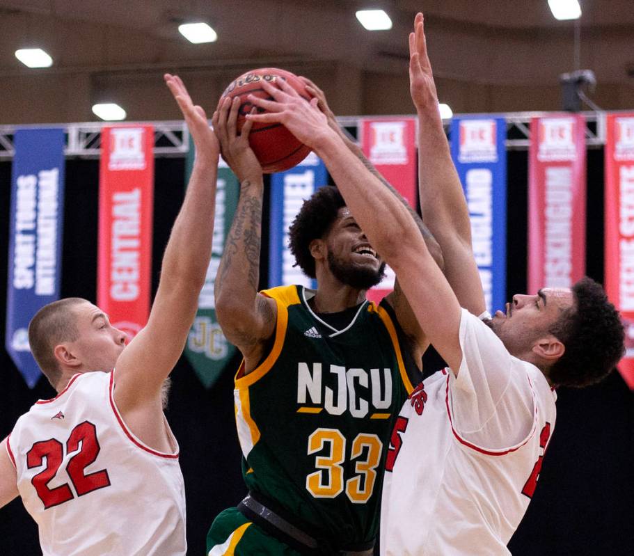 New Jersey City University's center Quadri Moore (33) shoots a point as University of Wisconsin ...