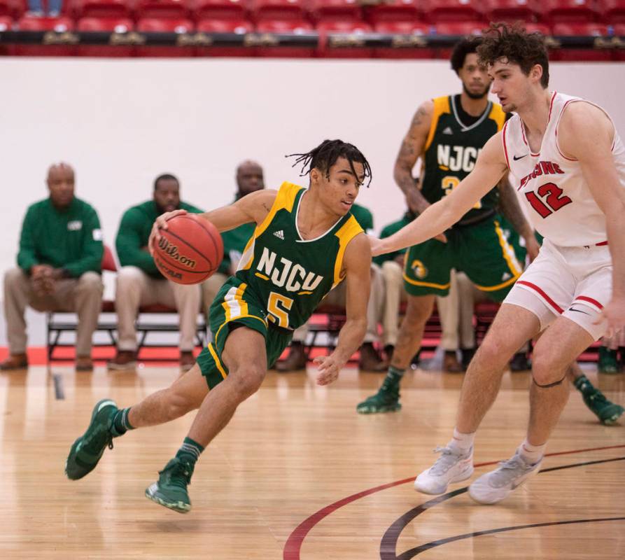 New Jersey City University's point guard Kyree Myers (5) dribbles down the court past Universit ...