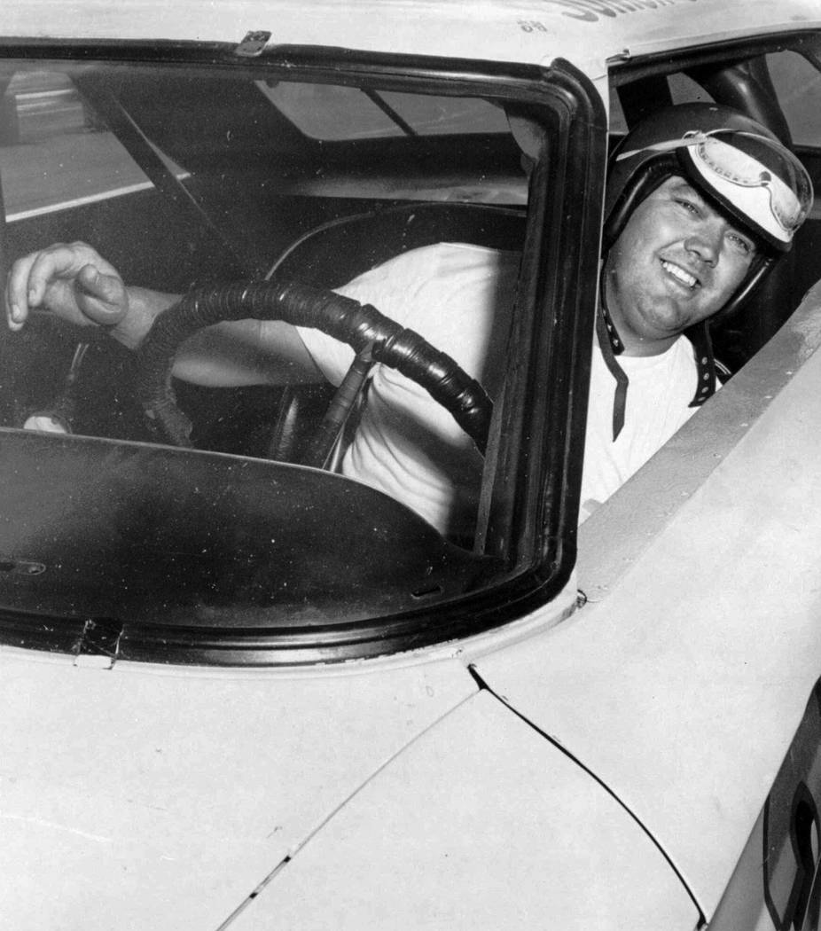 In this June 3, 1964, photo, Junior Johnson peers from his car after winning the pole position ...