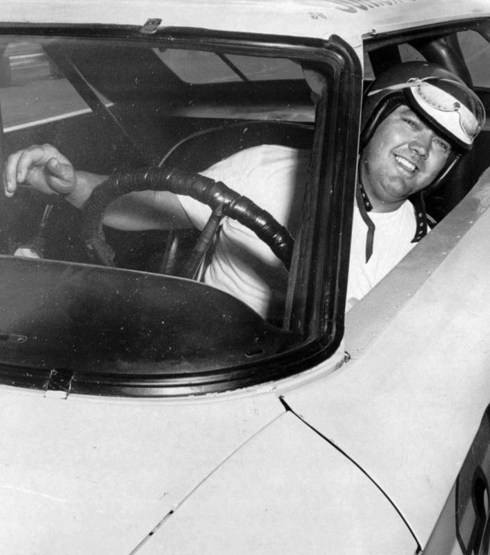 In this June 3, 1964, photo, Junior Johnson peers from his car after winning the pole position ...