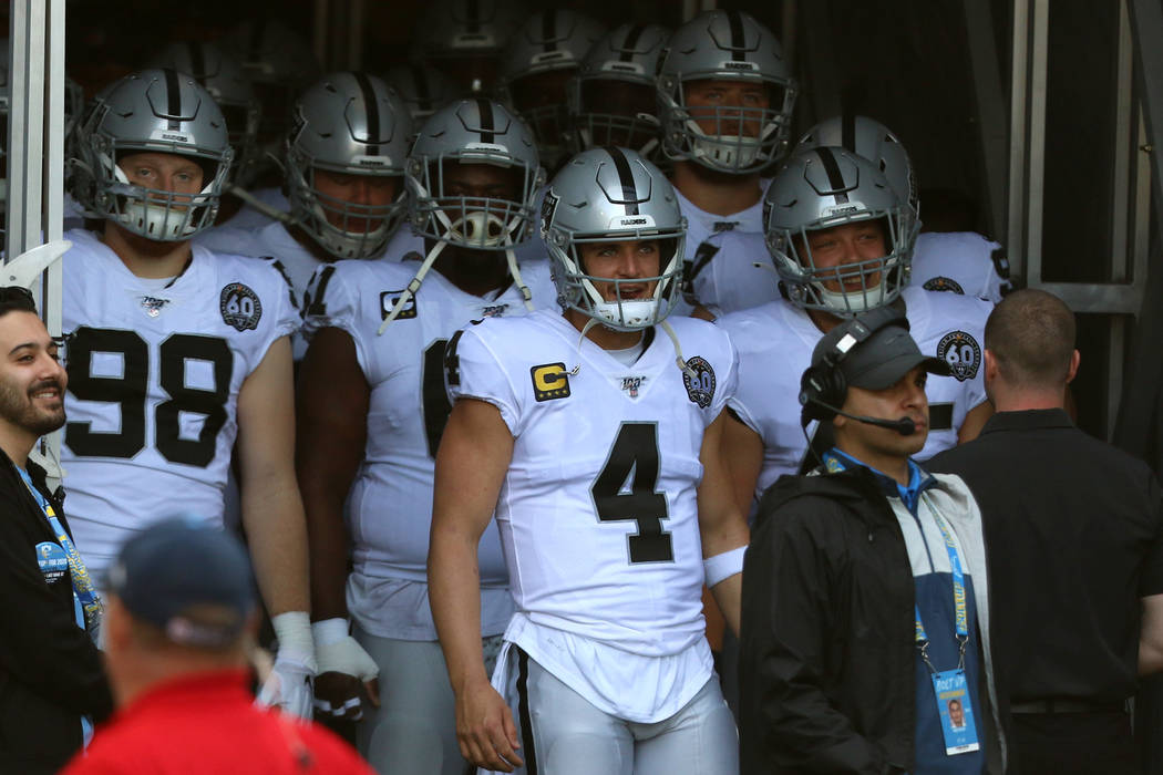 Oakland Raiders quarterback Derek Carr (4) prepares to lead the team out on the field as he is ...