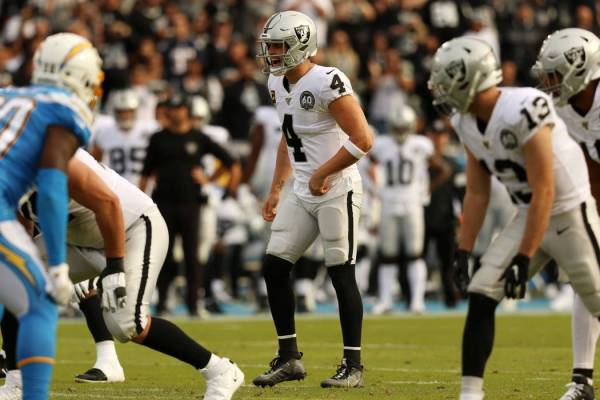 Oakland Raiders quarterback Derek Carr (4) calls an audible at the line of scrimmage during the ...