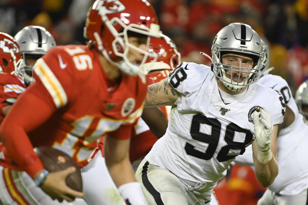 Oakland Raiders defensive end Maxx Crosby (98) chases Kansas City Chiefs quarterback Patrick Ma ...