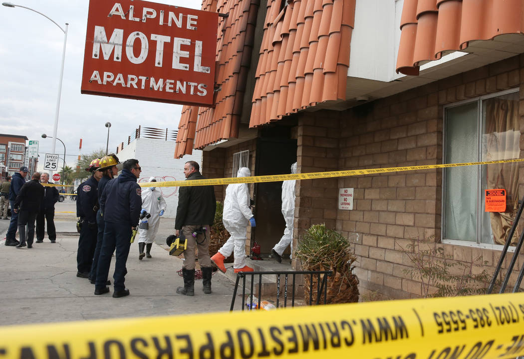 Las Vegas Fire Department investigators with assistance from Las Vegas police enter the Alpine ...