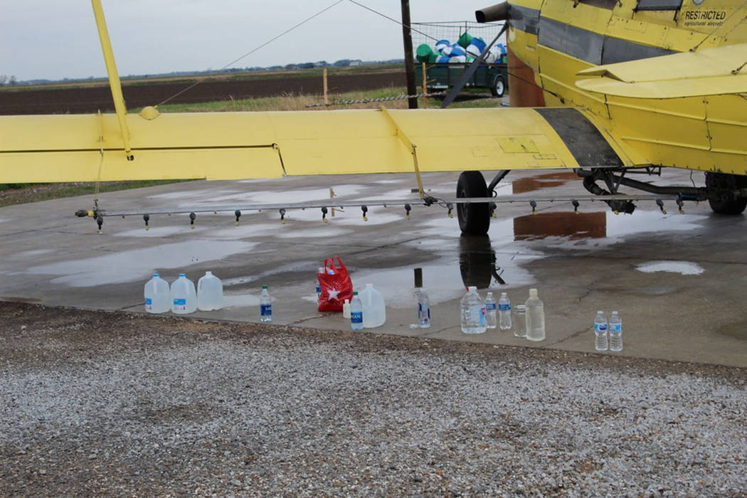 Members of St. Anne Church in Cow Island, Louisiana, called upon crop duster pilots to help spr ...