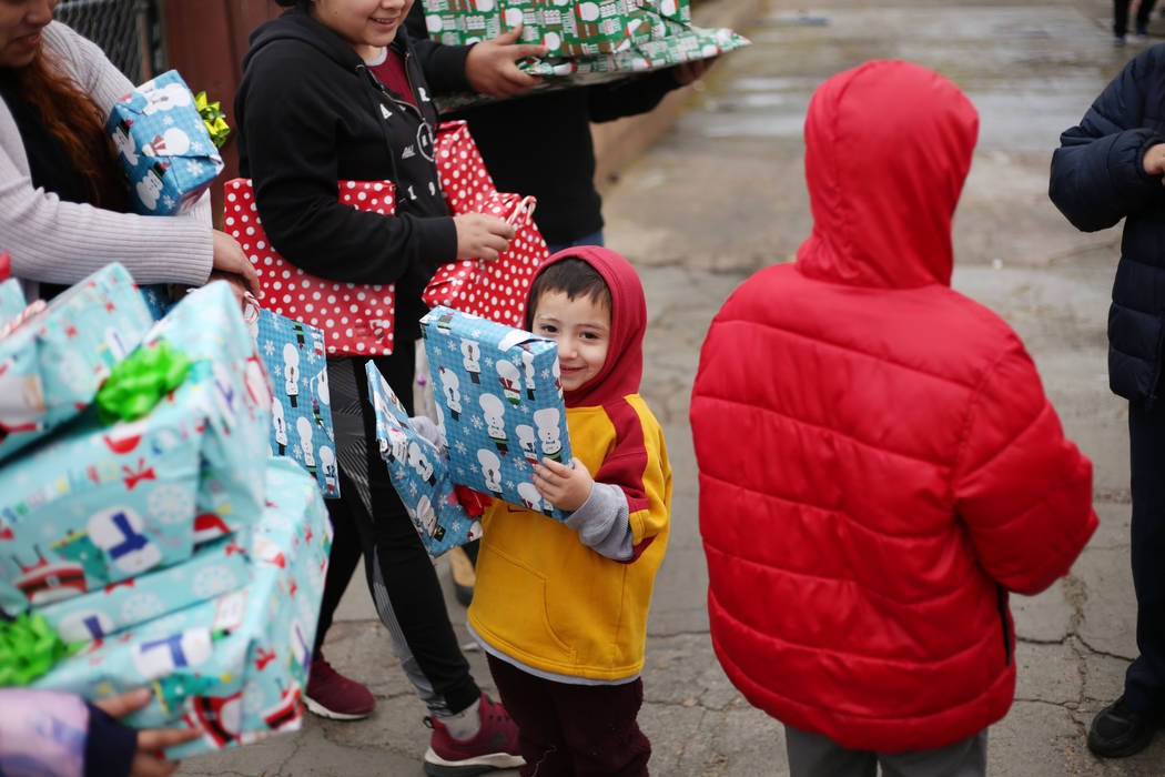 Ruben Figueroa, 3, holds his gifts at his home in North Las Vegas on Tuesday, Dec. 24, 2019. El ...