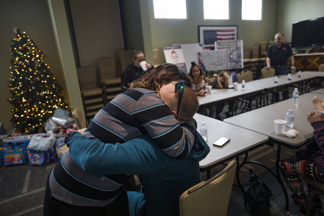 Michelle Aikens hugs her husband Michael Aikens, both survivors of the Alpine Motel fire, at SH ...