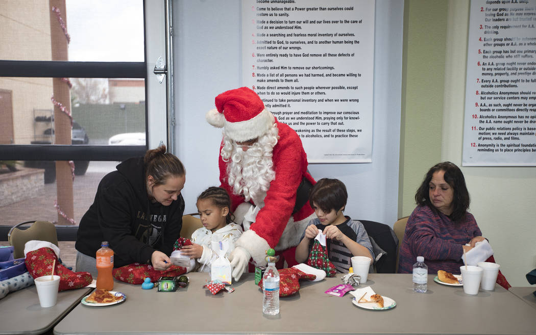 Santa Claus passes out gifts to the survivors of the Alpine Motel fire that killed six people a ...