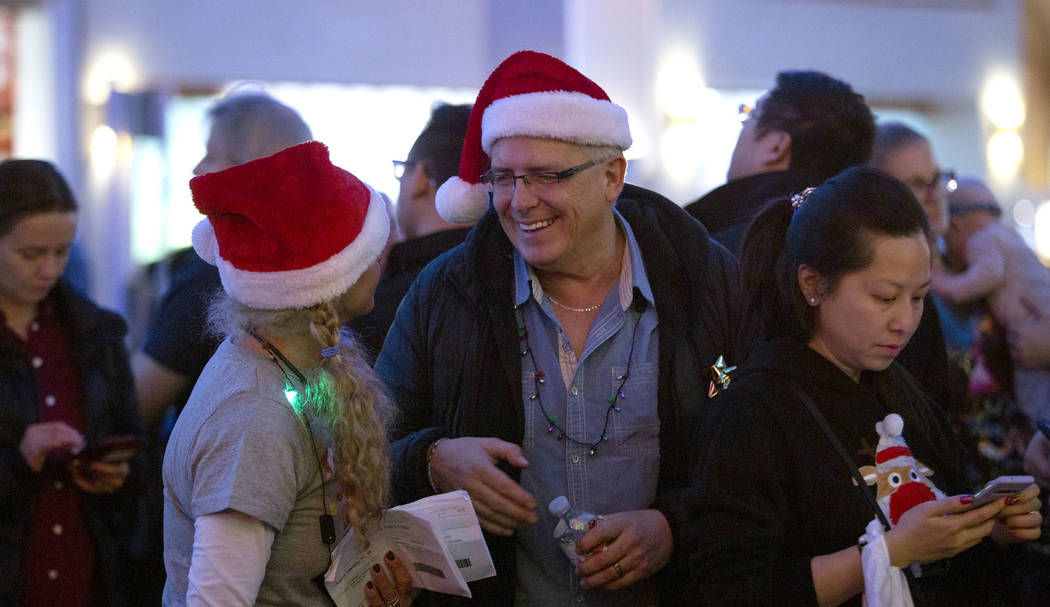 Sherri Bobowsky, left, chats with Michael Ostopowich, right as they wait in line outside V Thea ...