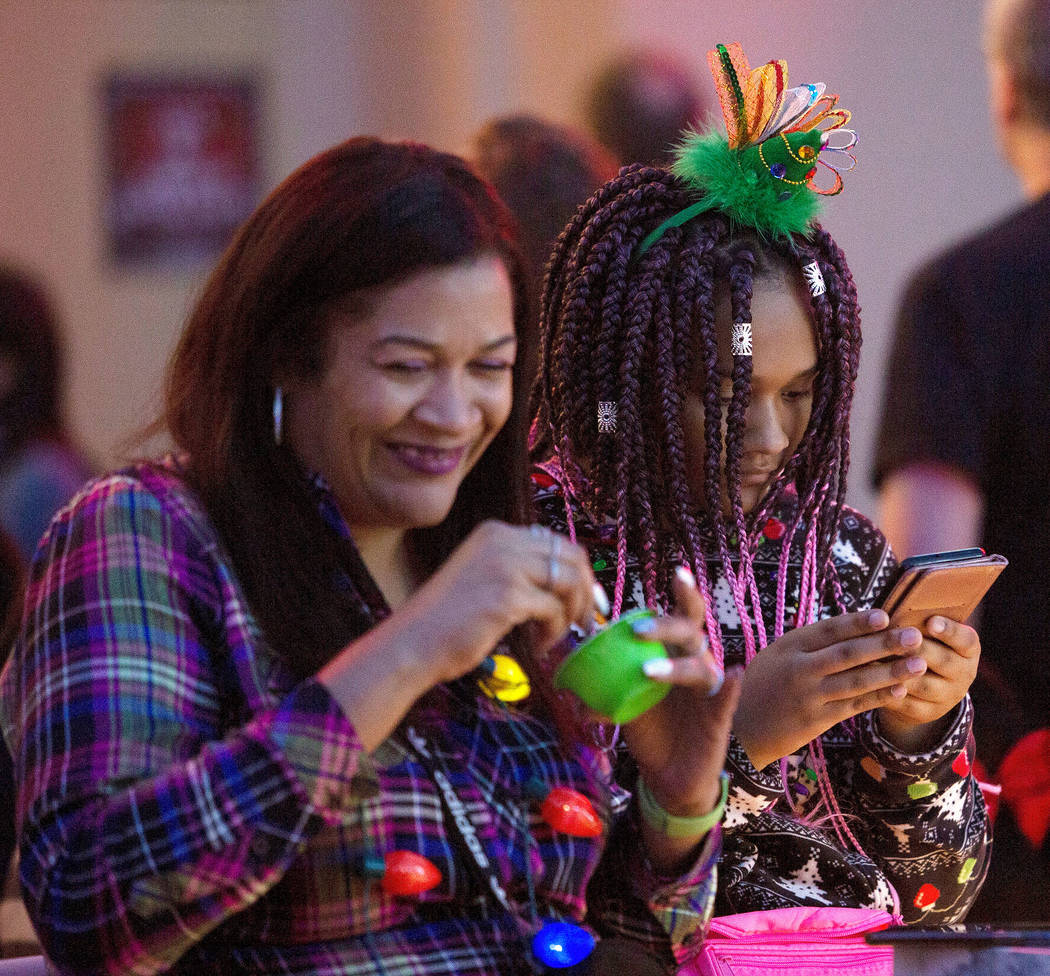 Tasha Williams, left, and Marley Glidden, 14, right, of Florida, wait for the rest of their fam ...