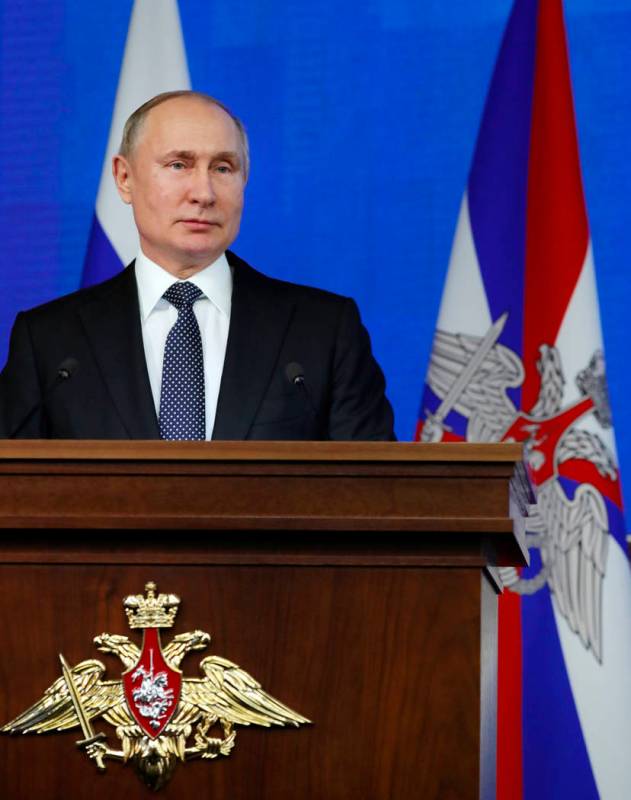 Russian President Vladimir Putin delivers his speech during an annual meeting with top military ...