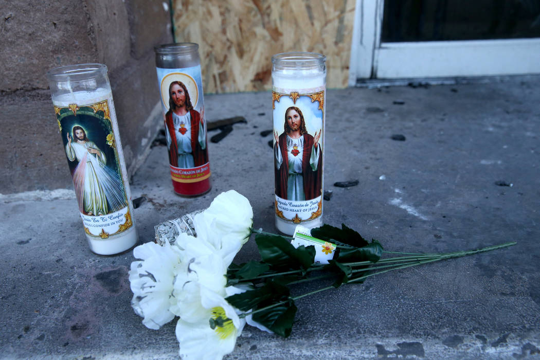 Flowers and candles at the Alpine Motel Apartments, Wednesday, Dec. 25, 2019, after six people ...