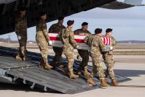 An Army carry team moves a transfer case containing the remains of U.S. Army Sgt. 1st Class Mic ...