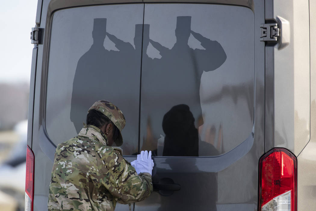 U.S. Air Force Tech. Sgt. Shaquita Darby closes the door of a vehicle containing a transfer cas ...