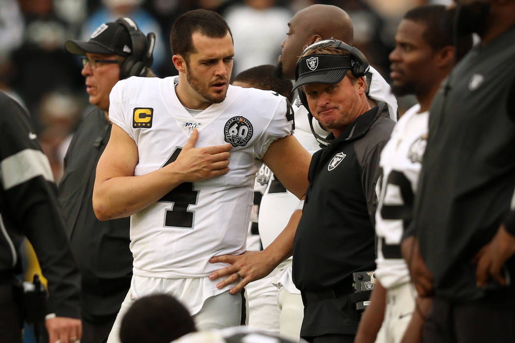 Oakland Raiders quarterback Derek Carr (4) speaks with head coach Jon Gruden on the sideline du ...