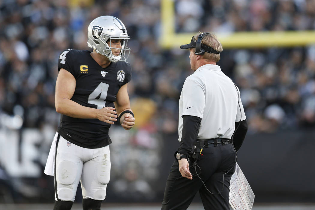 Oakland Raiders quarterback Derek Carr (4) talks with head coach Jon Gruden during the second h ...