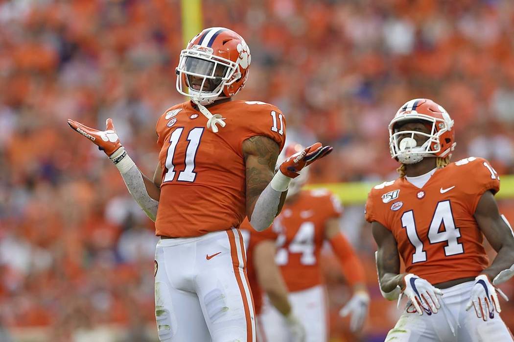 In this Oct. 12, 2019, file photo, Clemson's Isaiah Simmons (11) and Denzel Johnson react after ...